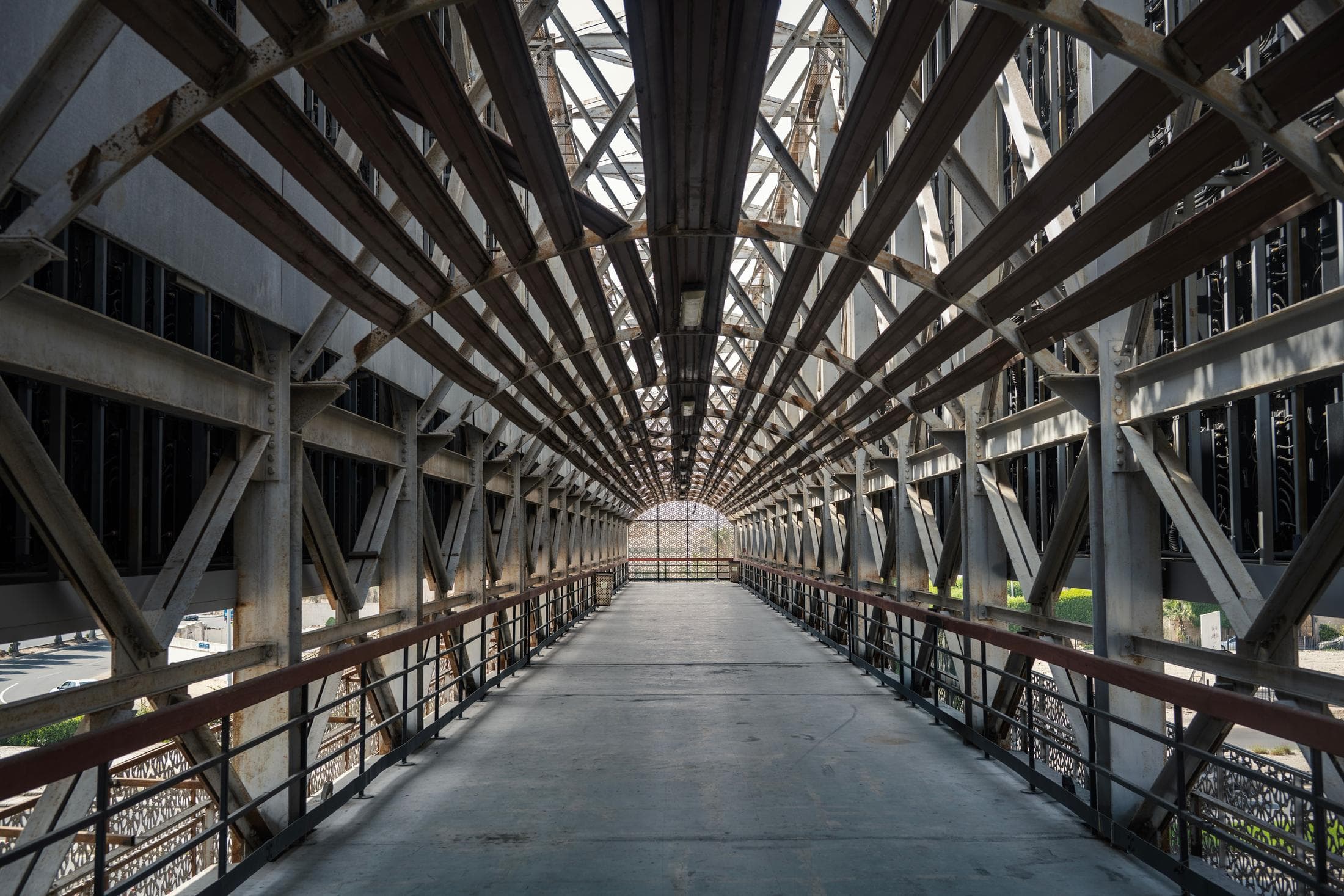 Elevated steel access platform and walkway with grating and handrails in an industrial building